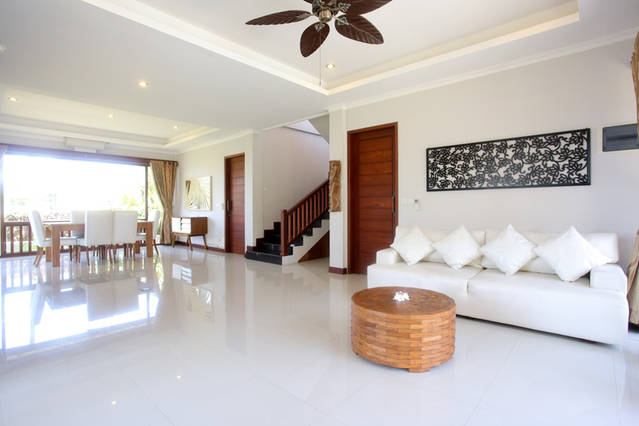 Lounge and dining area with views of sea, river and swimming pool.