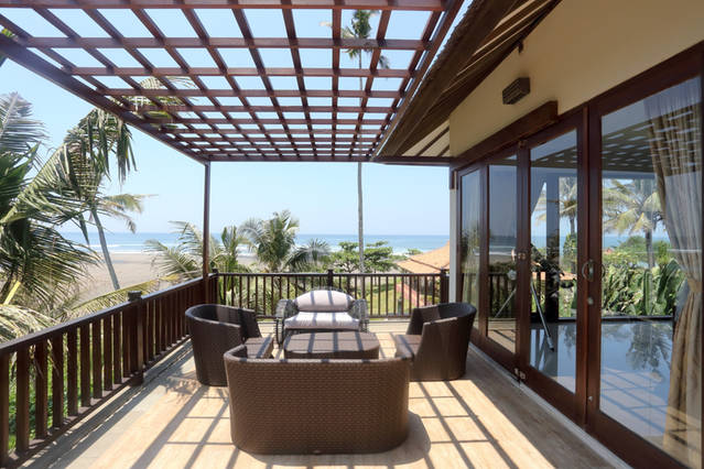 Upstairs terrace directly overlooks surf break and river.